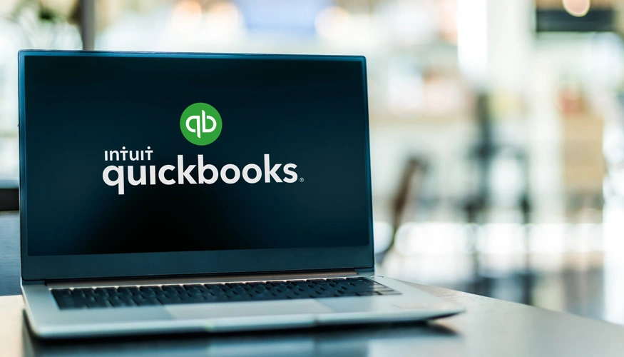 Accountant using laptop and financial documents